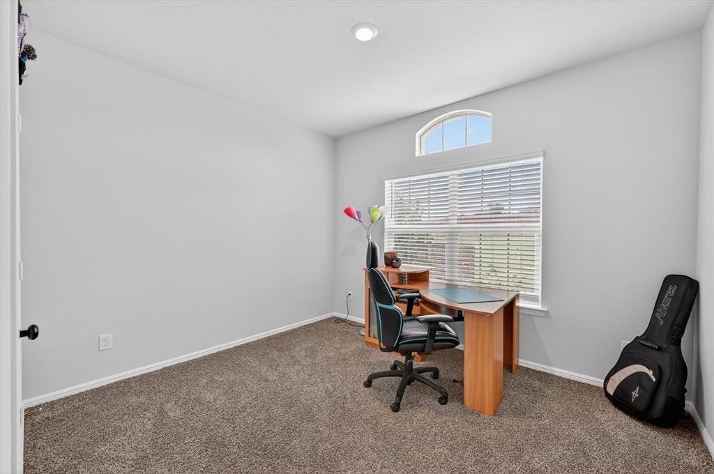9604 Cherryville Road Fort Worth, TX 76108 - Photo 26 of 40 Carpeted room featuring a large window with horizontal blinds and an arched transom window above