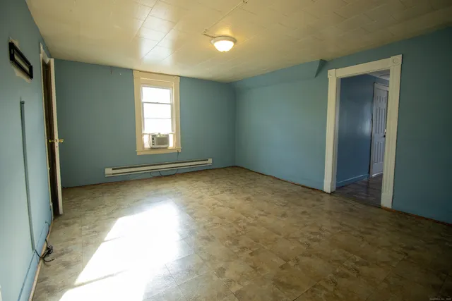 an empty room with windows and closet
