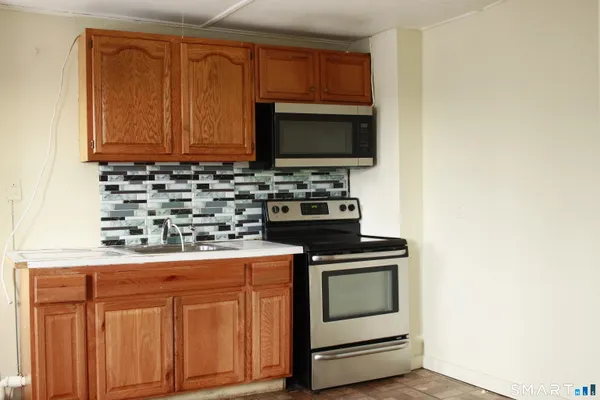 a kitchen with stainless steel appliances a stove and a microwave