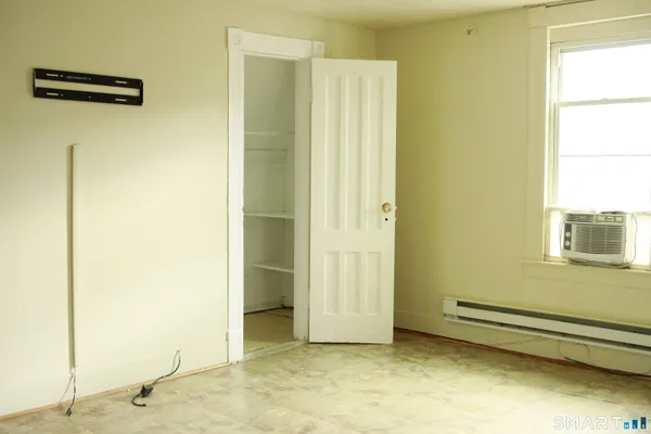 a view of a room with wooden floor
