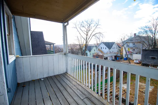 a view of balcony with wooden floor and fence
