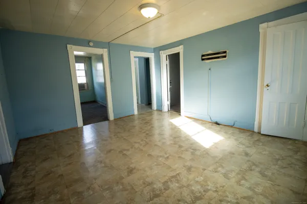 an empty room with closet and a bathroom