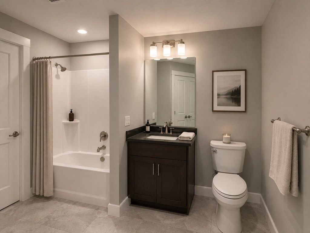 269 Main Street, Unit 2006 Reading, MA 01867 - Photo 5 of 10 a bathroom with a granite countertop toilet a sink and bathtub