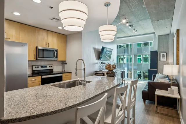 a kitchen with stainless steel appliances granite countertop a sink and a stove