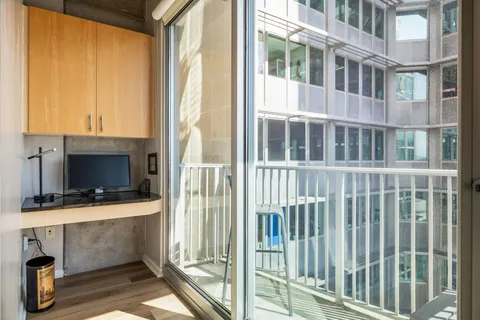 a view of balcony with furniture and a window