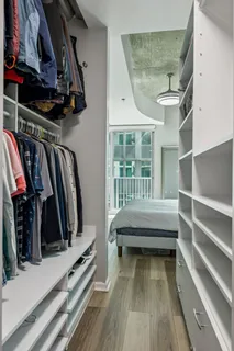 a view of walk in closet with clothes and shoes
