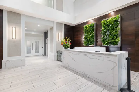 a living room with furniture and large windows