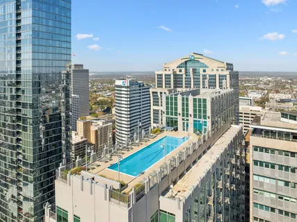 a view of a swimming pool and outdoor seating