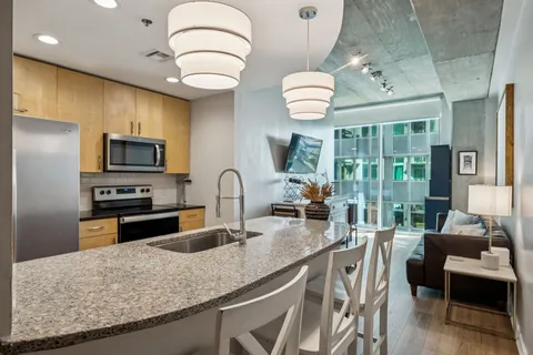 a kitchen with stainless steel appliances granite countertop a sink and a stove