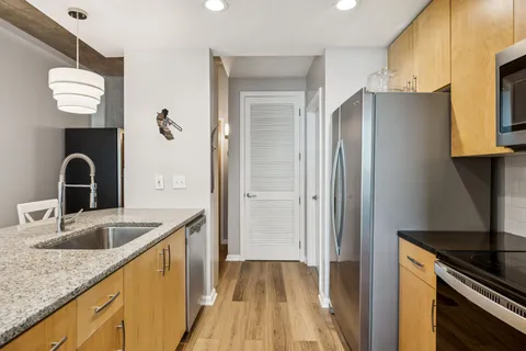 a kitchen with a refrigerator and a sink