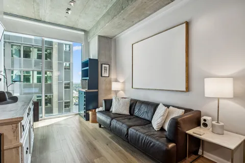 a living room with furniture and a lamp