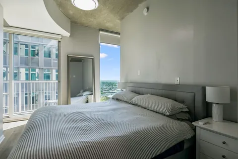 a bedroom with a bed and a lamp with window