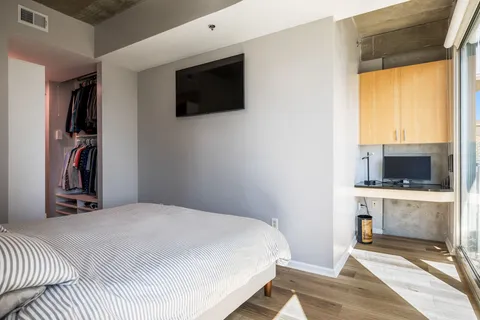 a bedroom with a bed and a flat screen tv
