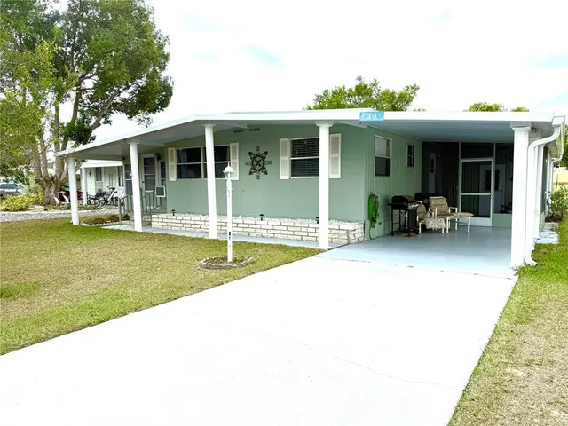a view of a house with swimming pool and sitting area