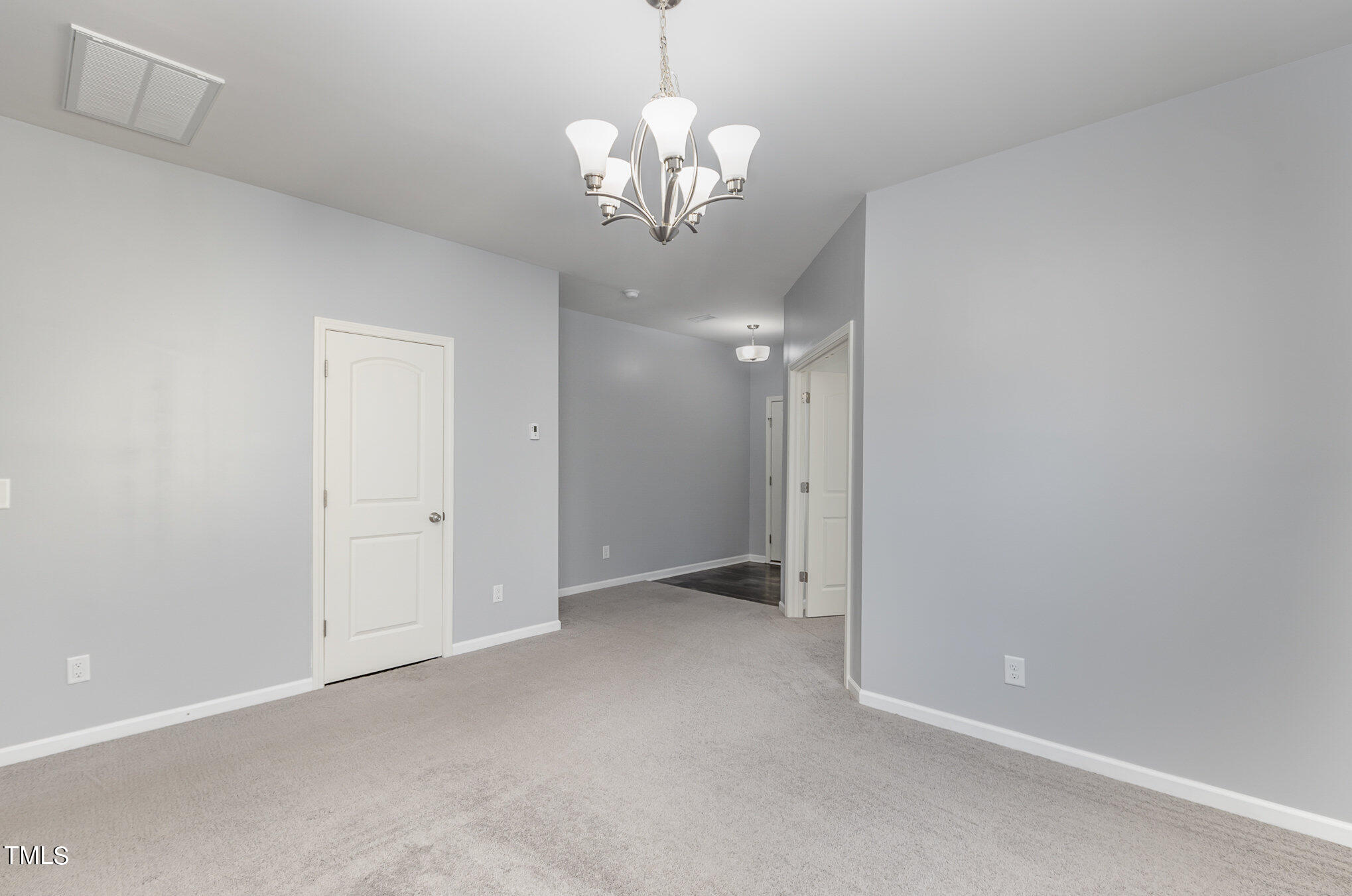 500 Hidden Den Path Wendell, NC 27591 - Photo 14 of 36 a view of an empty room with a chandelier