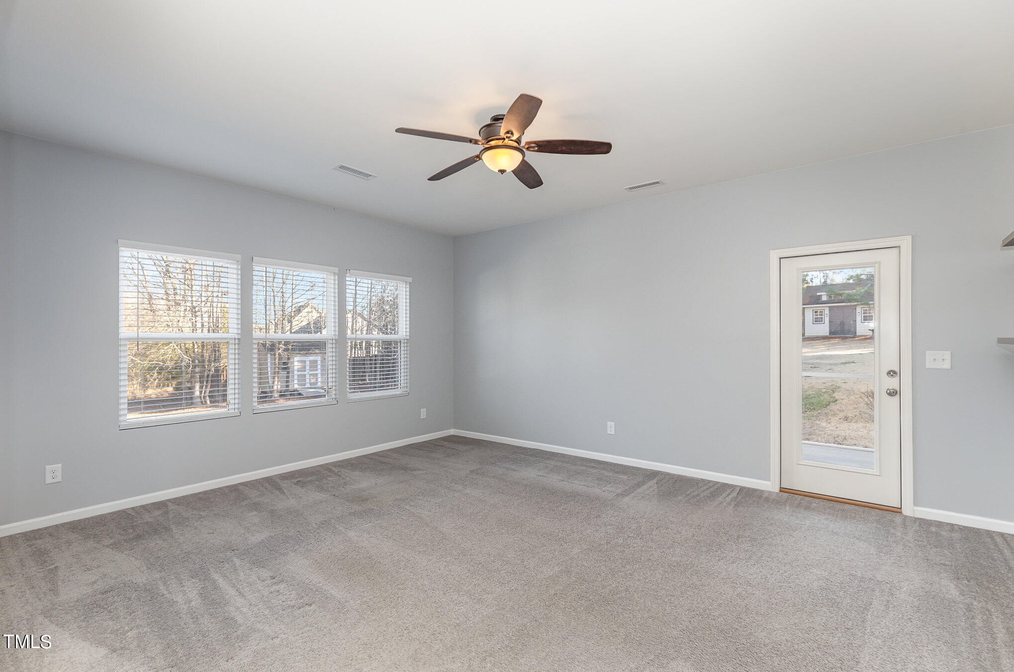 500 Hidden Den Path Wendell, NC 27591 - Photo 5 of 36 an empty room with windows and fan