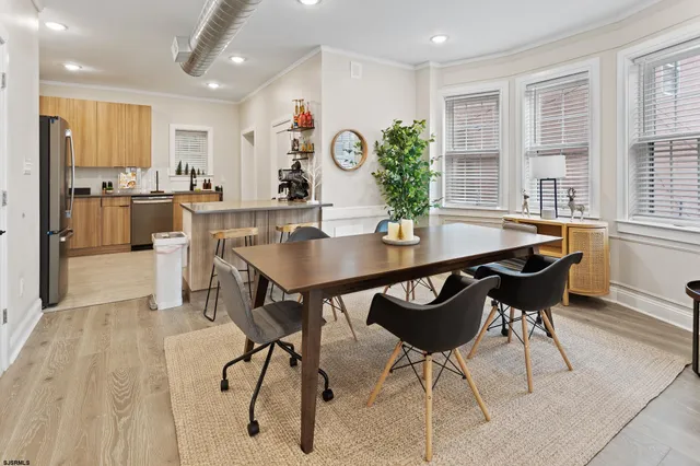 a view of a dining room with furniture and wooden floor