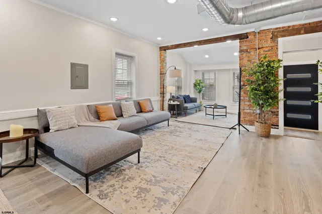 a living room with furniture and a potted plant