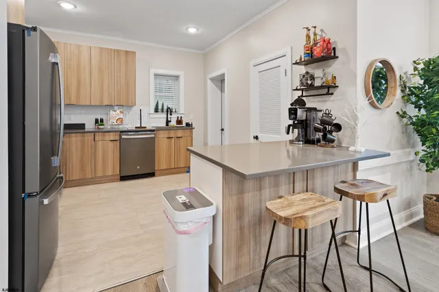 a kitchen with granite countertop a sink cabinets and appliances