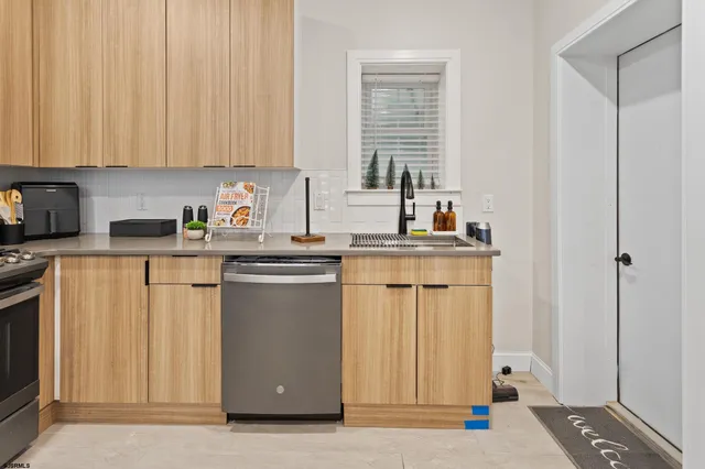 a kitchen with a sink cabinets and window