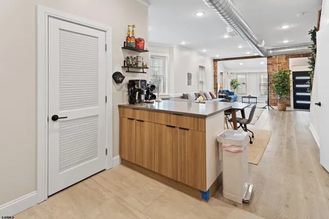 a view of a kitchen with appliances and furniture