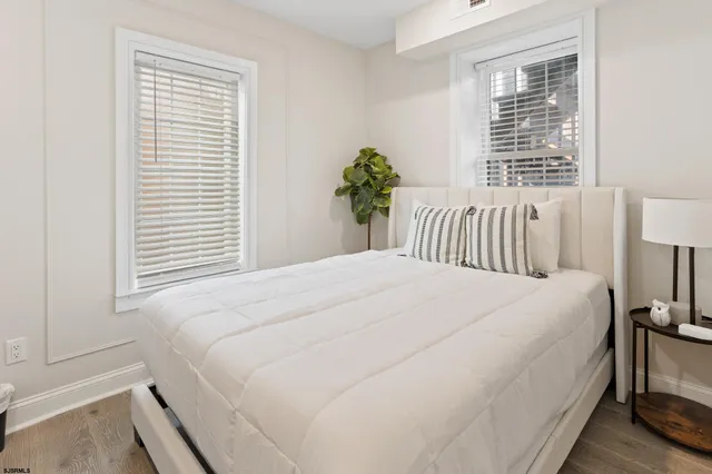 a bedroom with a bed and a potted plant
