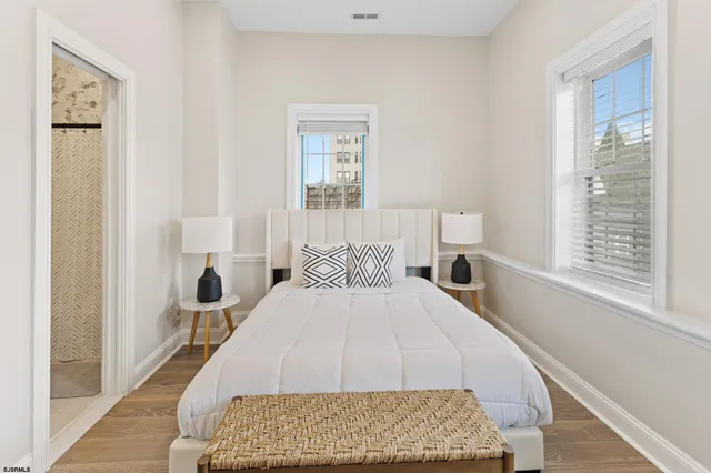 a bedroom with a bed and wooden floor