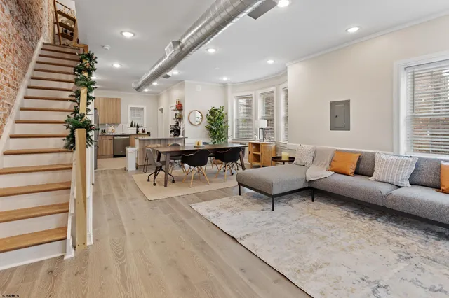a living room with furniture and wooden floor