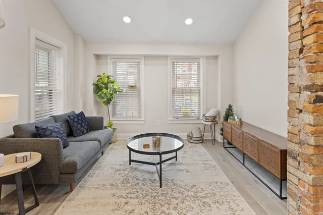 a living room with furniture and a potted plant
