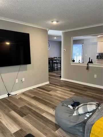a workspace with wooden floor and flat screen tv