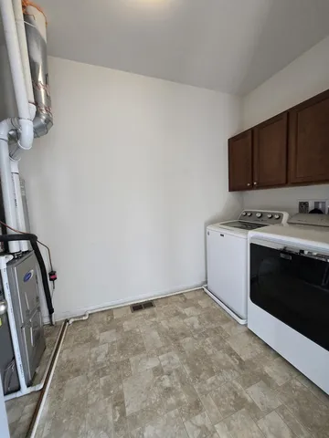 a view of a kitchen with washer and dryer