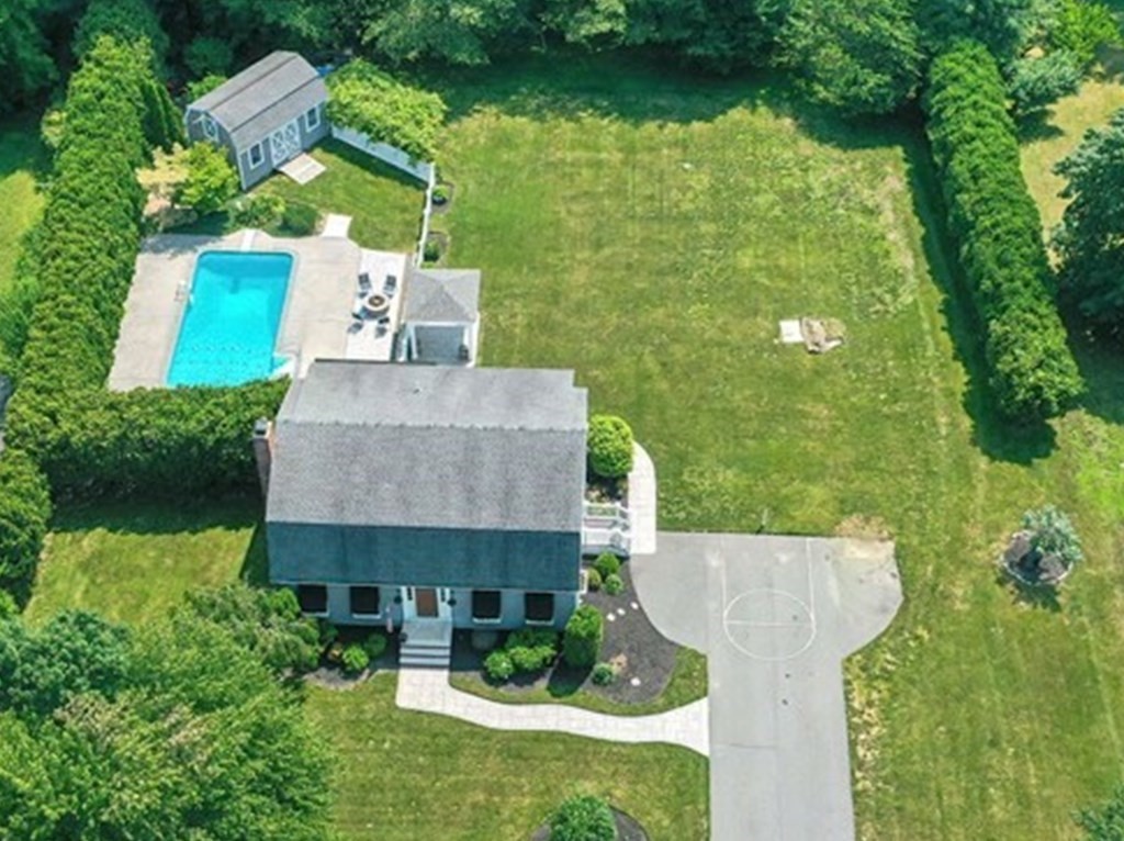 6 Reservation Road Acushnet, MA 02743 - Photo 1 of 42 an aerial view of a house with swimming pool and garden