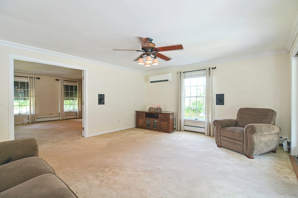 6 Reservation Road Acushnet, MA 02743 - Photo 20 of 42 a living room with furniture and a chandelier