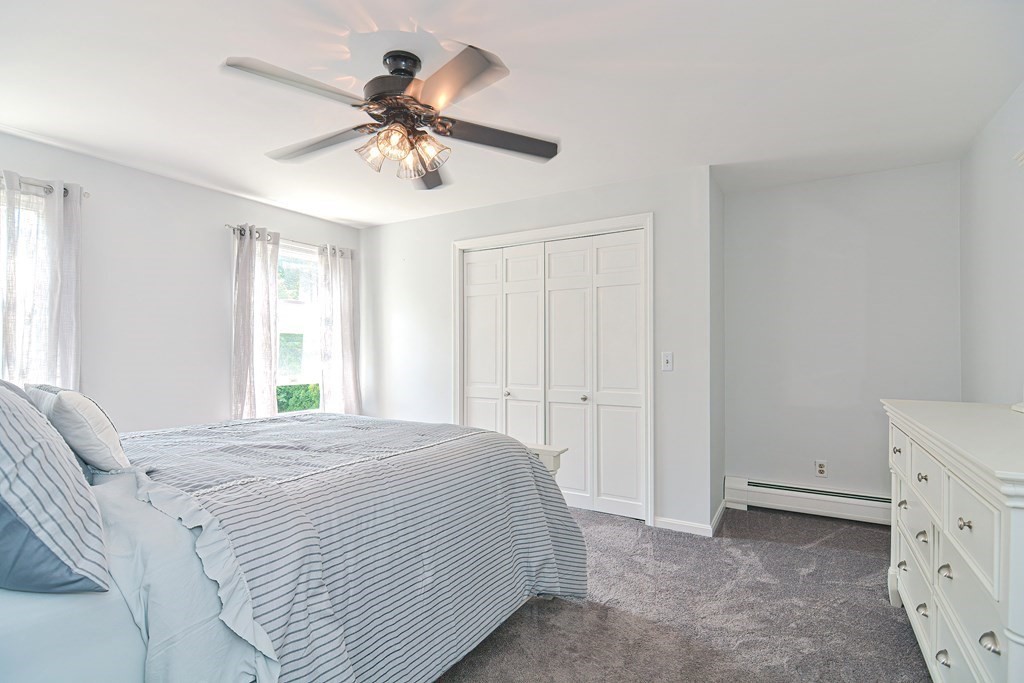 6 Reservation Road Acushnet, MA 02743 - Photo 28 of 42 a bedroom with a bed and a chandelier