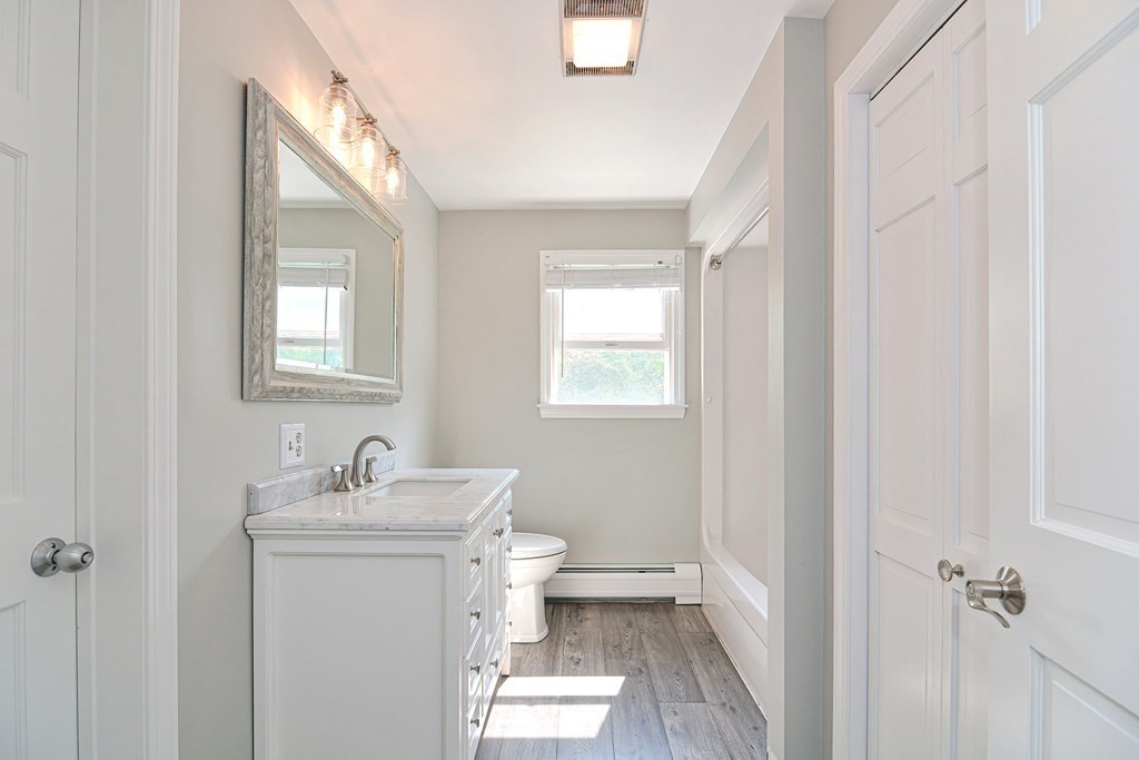 6 Reservation Road Acushnet, MA 02743 - Photo 31 of 42 a bathroom with a sink toilet and vanity