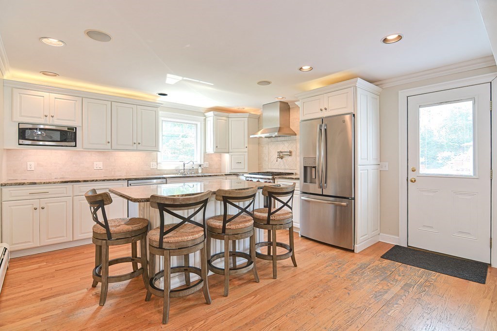 6 Reservation Road Acushnet, MA 02743 - Photo 9 of 42 a kitchen with stainless steel appliances granite countertop a dining table chairs refrigerator and microwave