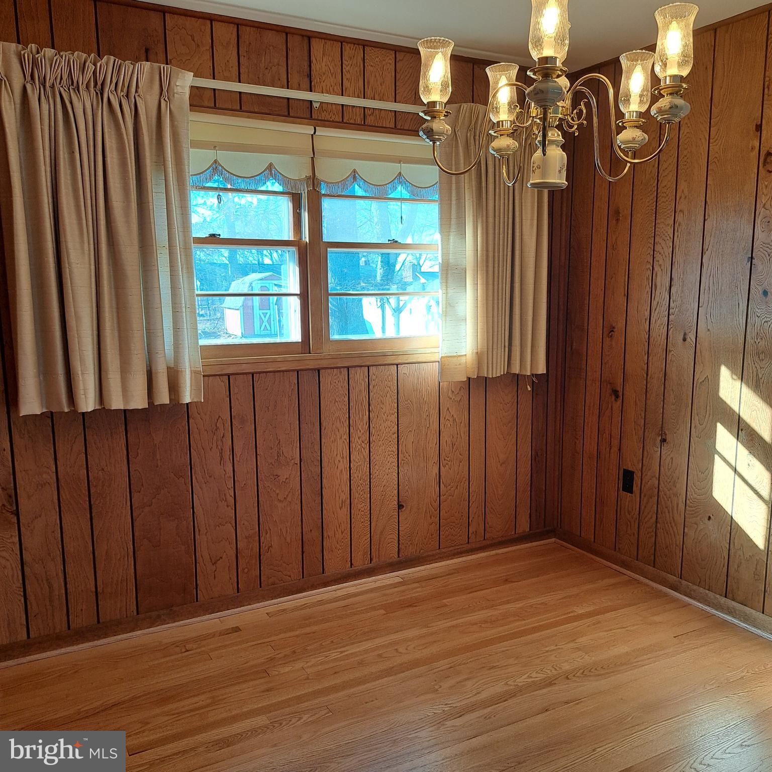 9301 Tuckerman Street Lanham, MD 20706 - Photo 16 of 48 an empty room with wooden floor and windows