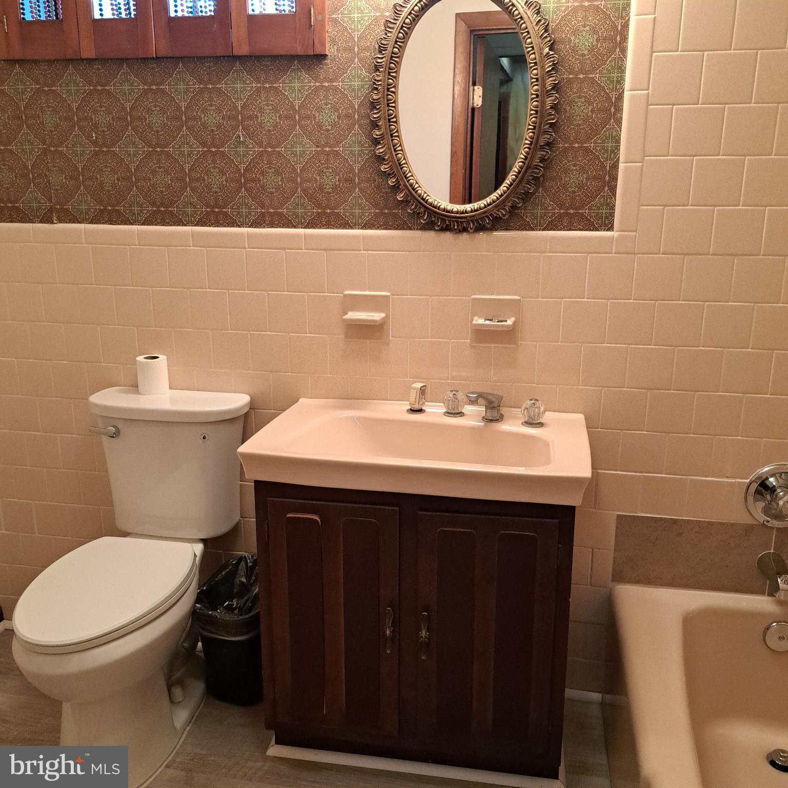 9301 Tuckerman Street Lanham, MD 20706 - Photo 30 of 48 a bathroom with a sink a toilet and a mirror