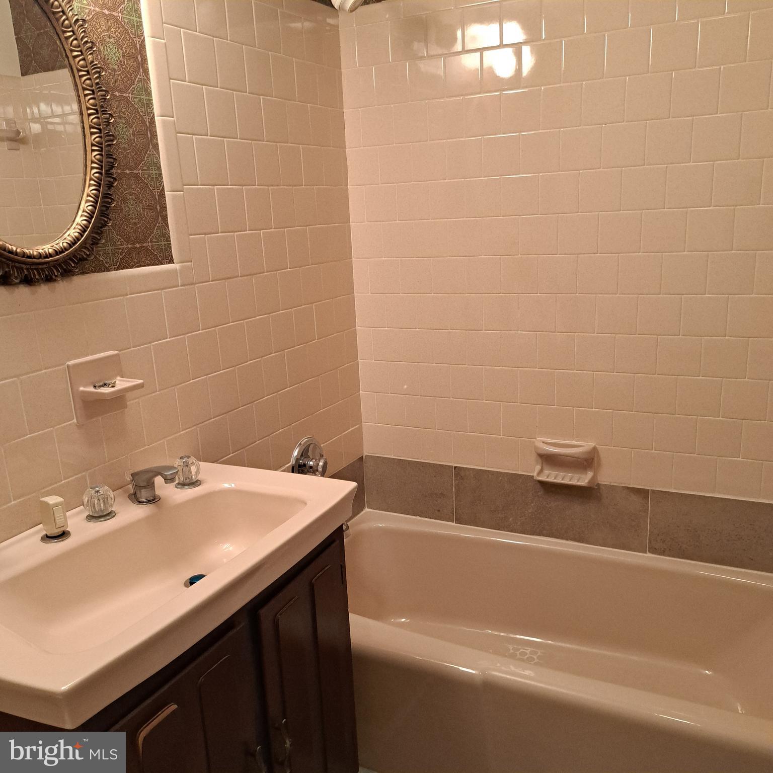 9301 Tuckerman Street Lanham, MD 20706 - Photo 31 of 48 a bathroom with a sink and a mirror