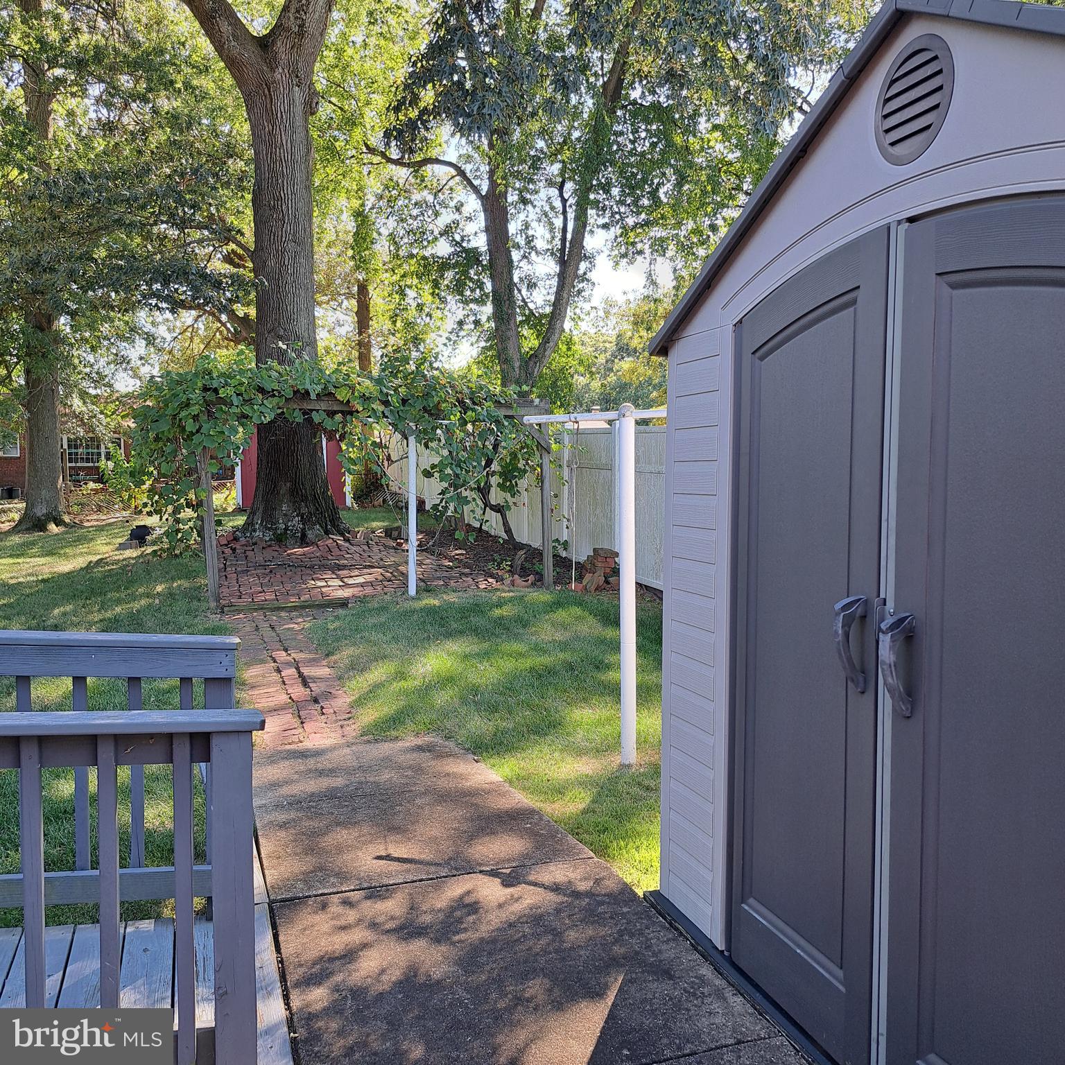 9301 Tuckerman Street Lanham, MD 20706 - Photo 6 of 48 a view of a backyard with couches plants and large trees