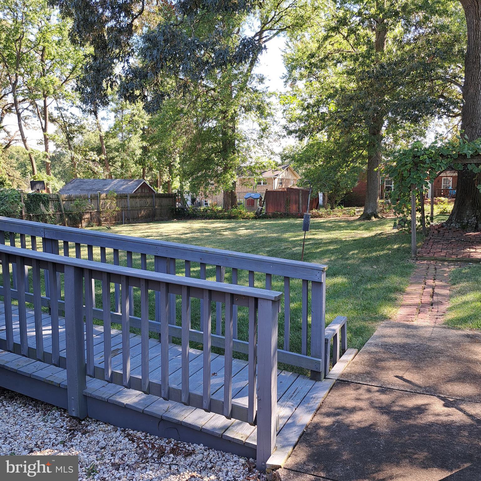 9301 Tuckerman Street Lanham, MD 20706 - Photo 8 of 48 a view of a wooden deck with a yard
