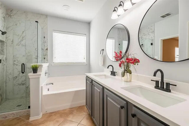 a bathroom with a tub sink and mirror