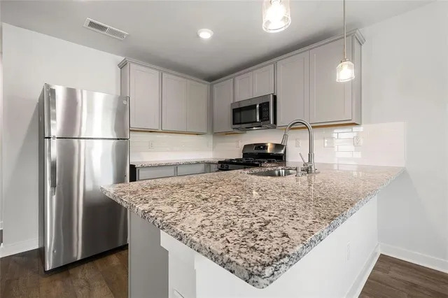 a white bath tub sitting next to a white sink and vanity