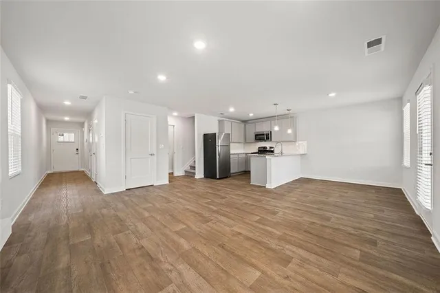 a kitchen with stainless steel appliances a refrigerator and a stove top oven