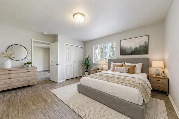 a spacious bedroom with a bed and a dresser