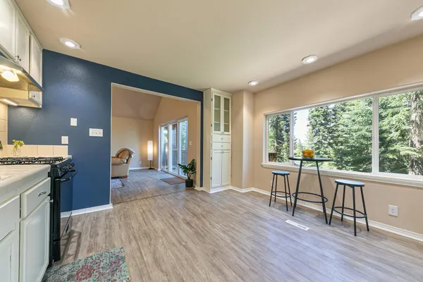 a view of a livingroom with furniture hardwood floor and a large window