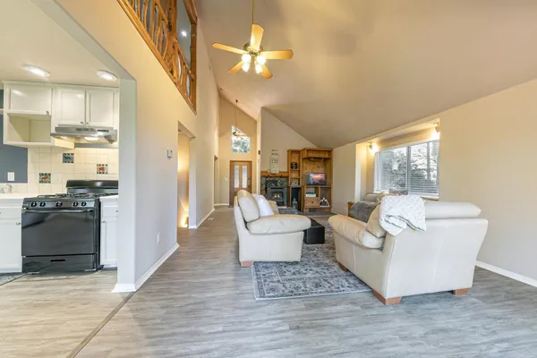 a living room with furniture and a kitchen view