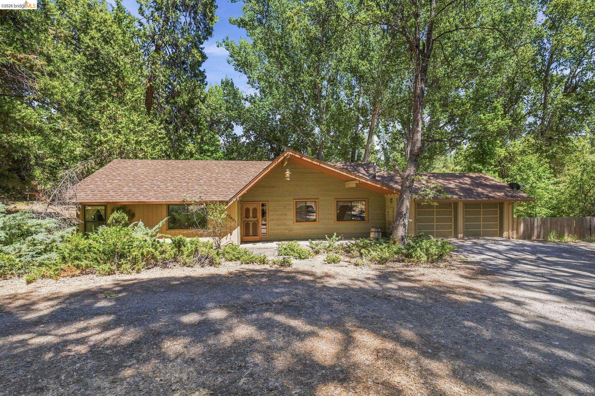 22401 South Fork Road Sonora, CA 95370 - Photo 1 of 34 Ranch-style exterior with a shingle roof and a two-car garage