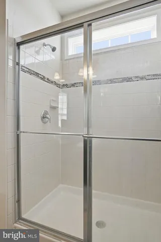 a bathroom with a glass shower door