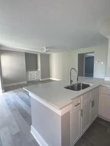 a kitchen with white cabinets and stainless steel appliances